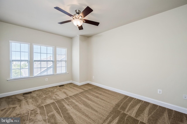 carpeted empty room featuring ceiling fan