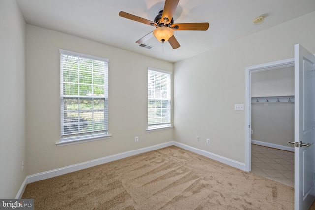 unfurnished bedroom featuring ceiling fan and light carpet