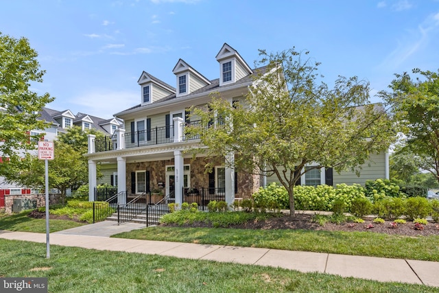 view of front of home with a front lawn and a porch