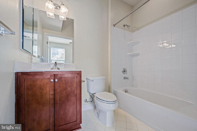 full bathroom featuring toilet, tiled shower / bath, vanity, and tile patterned floors