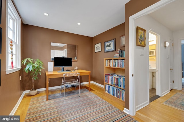 home office with hardwood / wood-style flooring and plenty of natural light