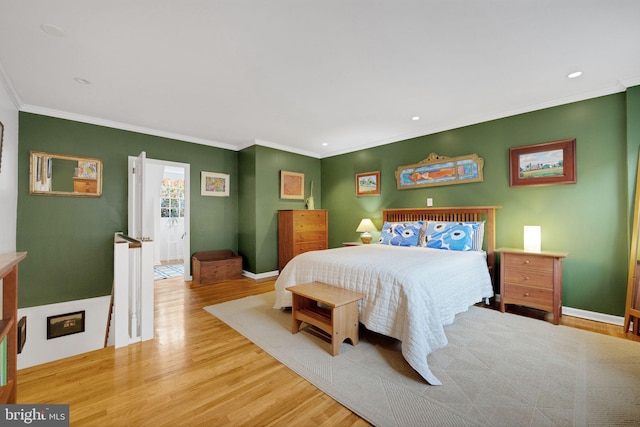 bedroom with hardwood / wood-style floors and crown molding