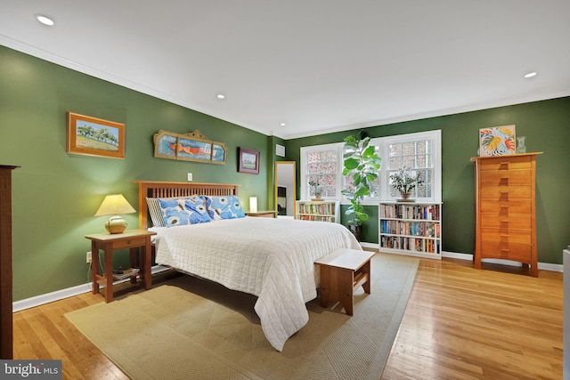 bedroom featuring light hardwood / wood-style flooring and ornamental molding