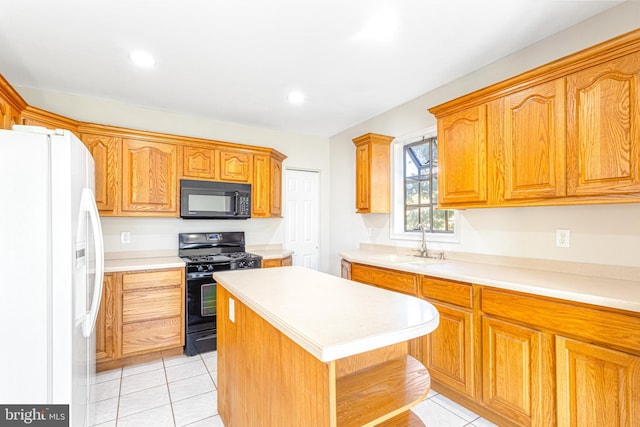 kitchen with sink, light tile patterned flooring, black appliances, and a center island