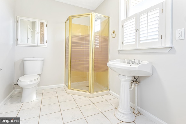 bathroom featuring tile patterned flooring, toilet, and an enclosed shower