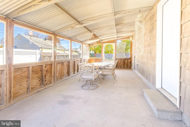 unfurnished sunroom featuring vaulted ceiling