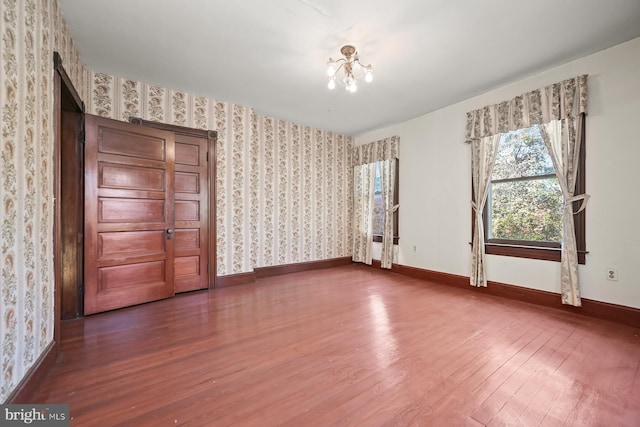 interior space with a notable chandelier and hardwood / wood-style flooring