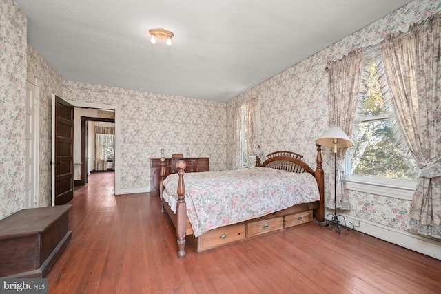 bedroom with dark hardwood / wood-style floors