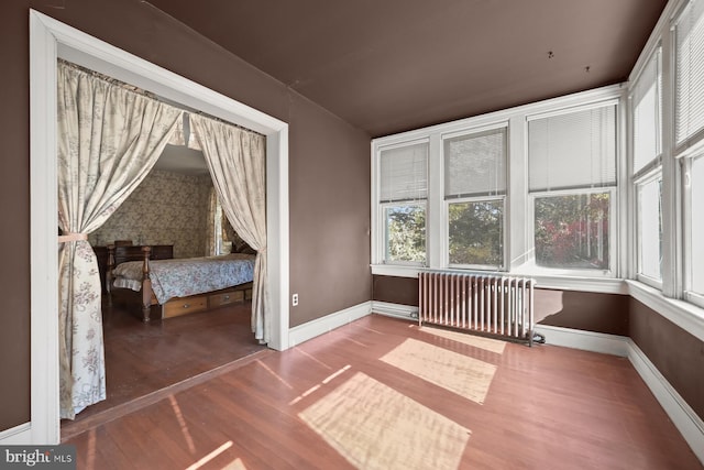 unfurnished sunroom featuring radiator