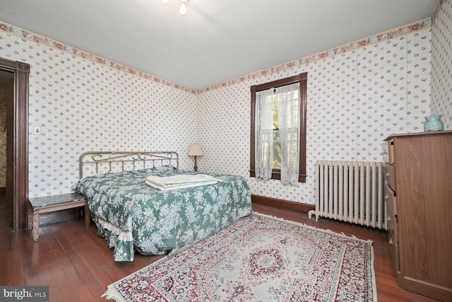 bedroom featuring dark hardwood / wood-style floors and radiator