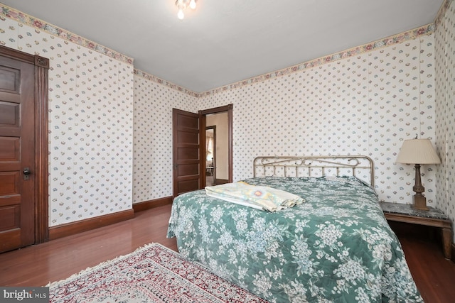 bedroom with dark wood-type flooring