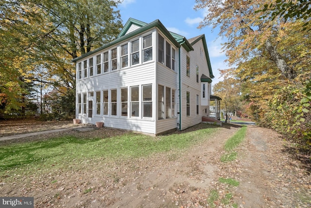 view of home's exterior featuring a sunroom