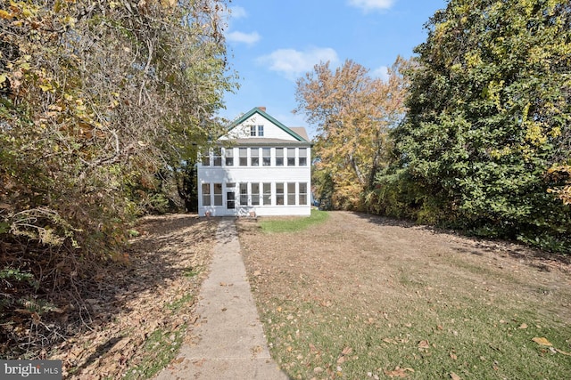 view of front of home with a sunroom