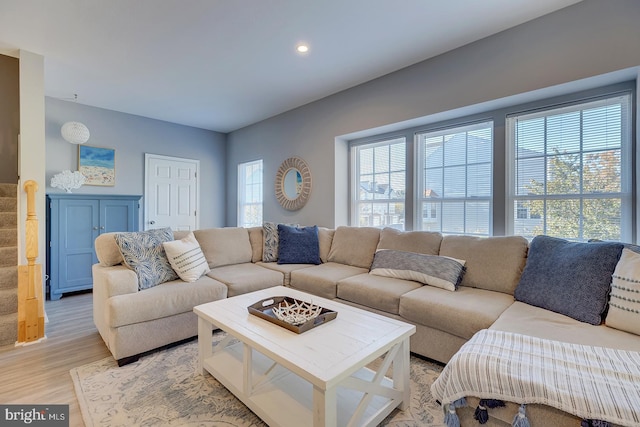 living room featuring a healthy amount of sunlight and light hardwood / wood-style flooring