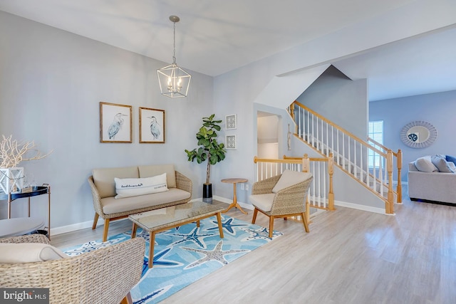 living room featuring light hardwood / wood-style flooring and an inviting chandelier