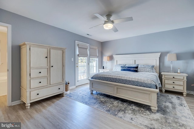 bedroom featuring hardwood / wood-style floors, access to exterior, and ceiling fan