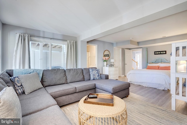 bedroom with multiple windows and light hardwood / wood-style flooring