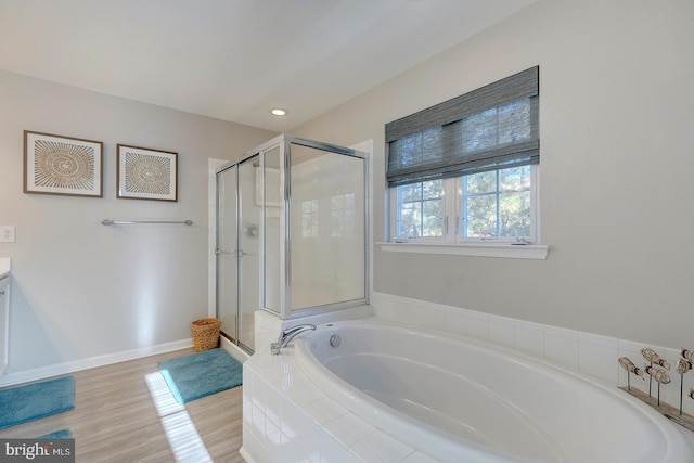 bathroom with vanity, separate shower and tub, and wood-type flooring