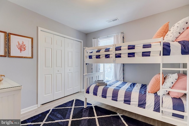 bedroom featuring a closet and light wood-type flooring