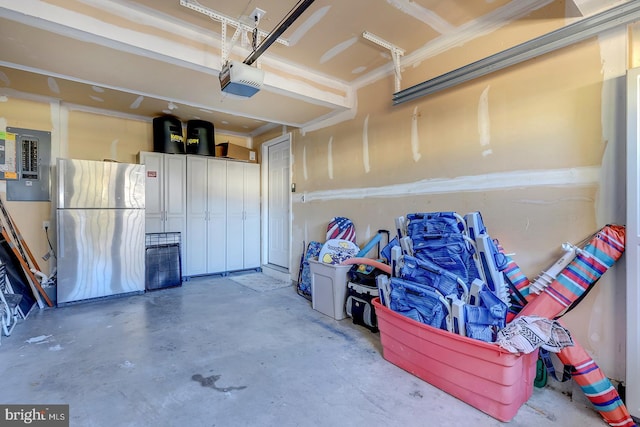 garage featuring a garage door opener and stainless steel refrigerator