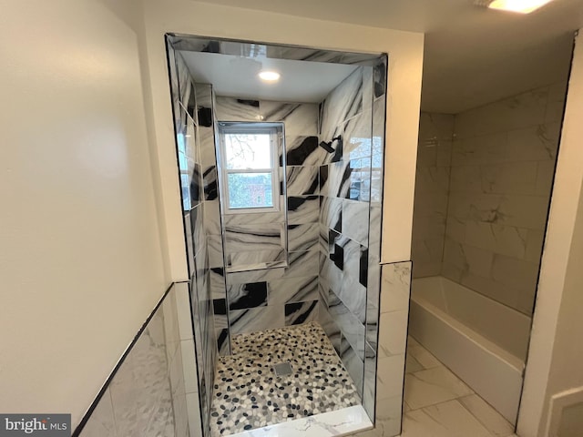 full bath with marble finish floor and tiled shower