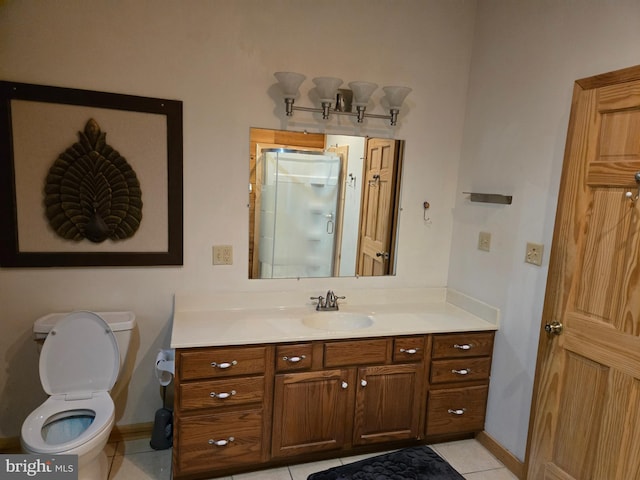 bathroom featuring tile patterned floors, toilet, baseboards, and vanity