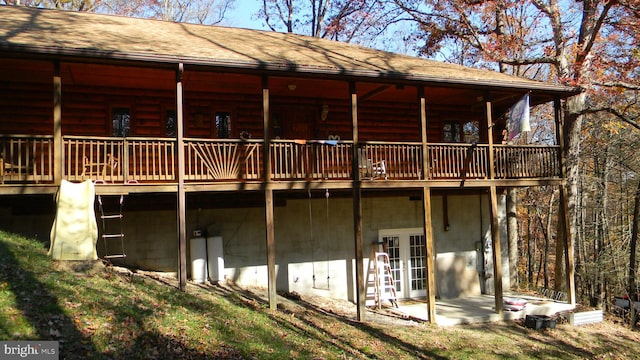 rear view of property with french doors and a wooden deck