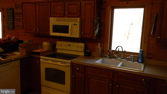 kitchen featuring sink and white appliances