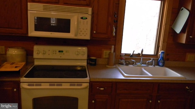 kitchen with decorative backsplash, sink, and white appliances