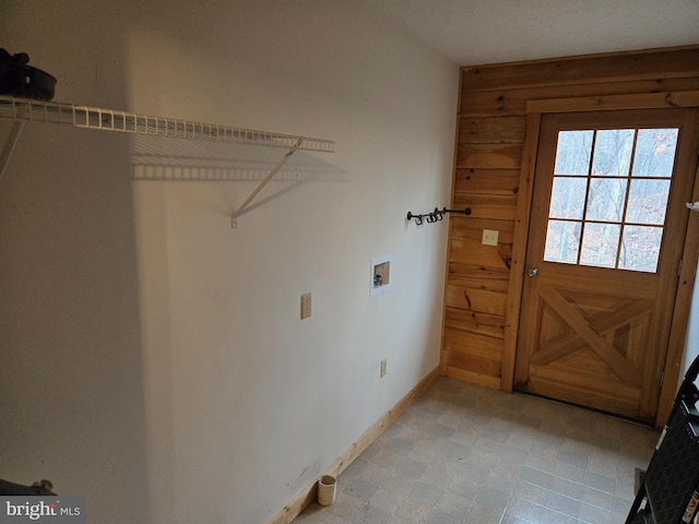 clothes washing area featuring baseboards, hookup for a washing machine, and laundry area