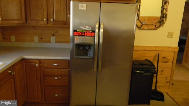 kitchen featuring light wood-type flooring and stainless steel fridge with ice dispenser