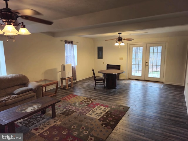 living room with electric panel, a ceiling fan, plenty of natural light, and dark wood finished floors