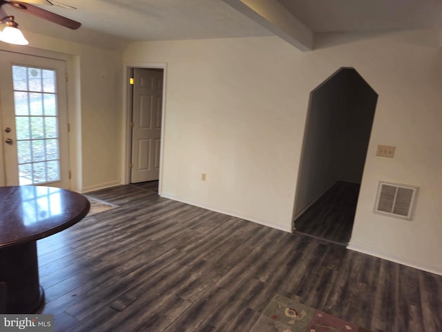 unfurnished living room with a ceiling fan, baseboards, dark wood finished floors, and visible vents