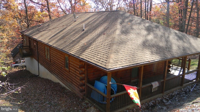 view of property exterior with a wooden deck