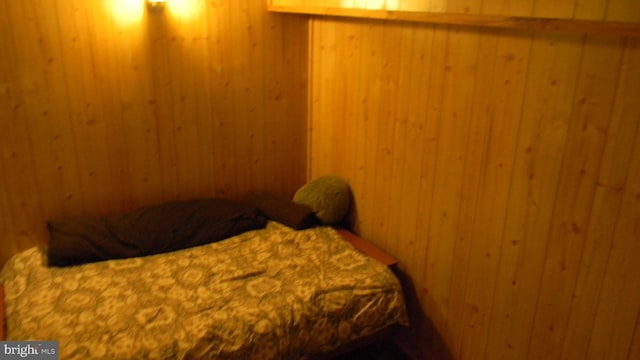 bedroom with wooden walls