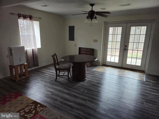 dining space featuring a healthy amount of sunlight, dark wood finished floors, french doors, and electric panel