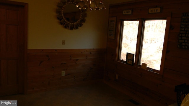 spare room with wood walls