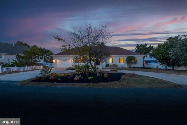 37763 Lagoon Ln, Ocean View, DE 19970 - ranch-style house with curved driveway, fence, and an attached garage