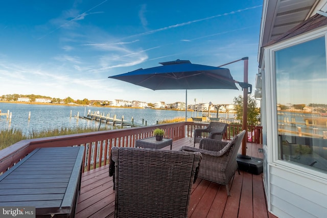 wooden terrace featuring a boat dock and a water view