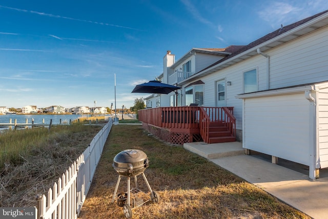 view of yard with a deck with water view