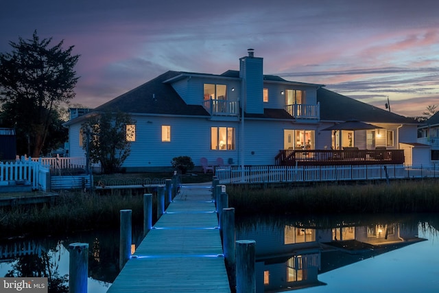 37763 Lagoon Ln, Ocean View, DE 19970 - back of house at dusk featuring a balcony, a chimney, and a water view