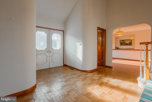 37763 Lagoon Ln, Ocean View, DE 19970 - entryway with a chandelier, baseboards, french doors, and high vaulted ceiling