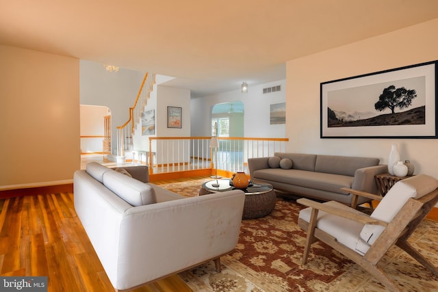 37763 Lagoon Ln, Ocean View, DE 19970 - living area featuring hardwood / wood-style flooring, arched walkways, stairway, and baseboards