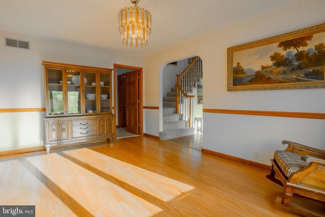 dining area featuring a chandelier and wood-type flooring