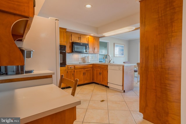 kitchen with light tile patterned floors, sink, tasteful backsplash, and black appliances