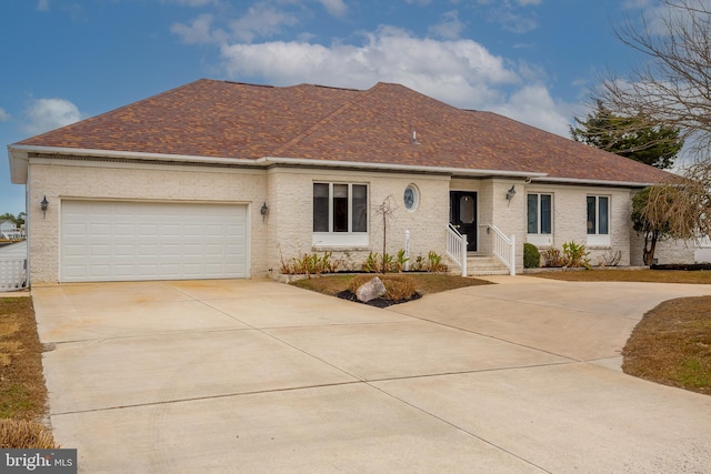 37763 Lagoon Ln, Ocean View, DE 19970 - ranch-style house with concrete driveway, a shingled roof, and an attached garage