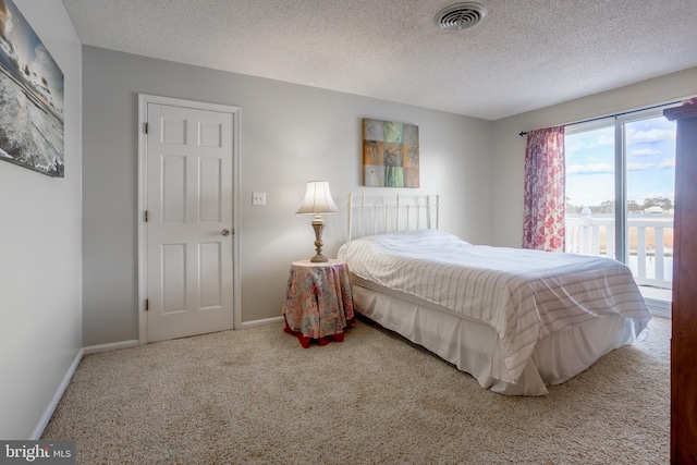 bedroom with carpet flooring and a textured ceiling