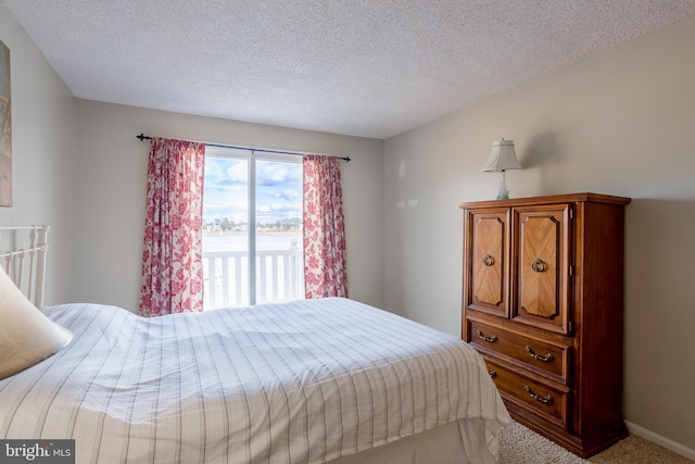 bedroom featuring carpet and a textured ceiling