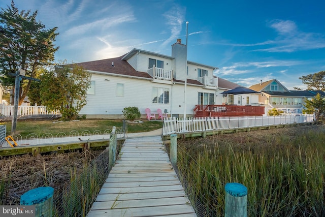 back of property featuring a balcony