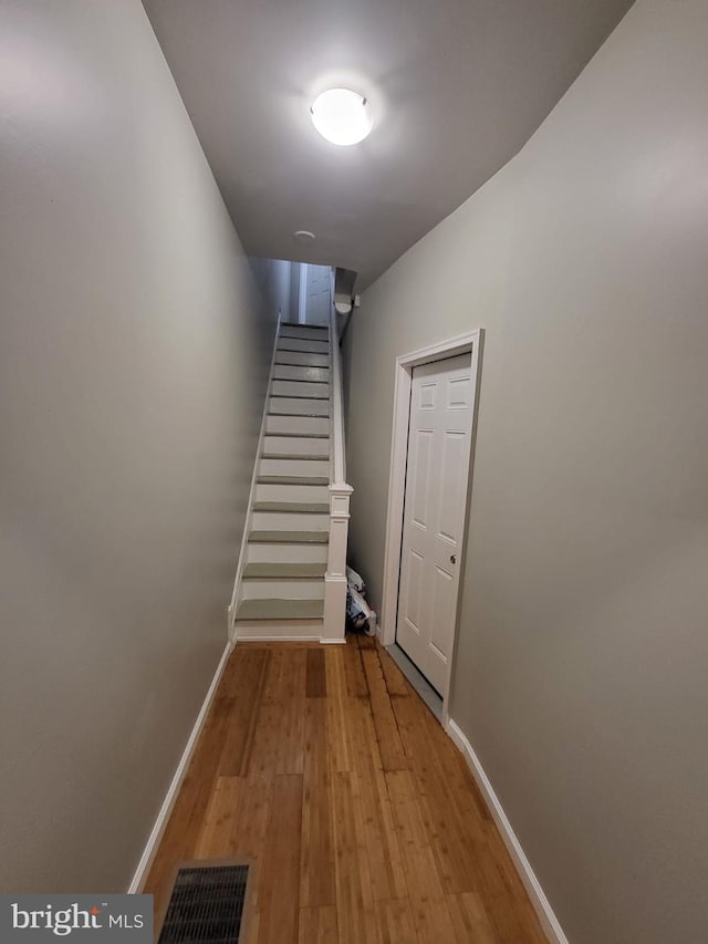 stairway featuring hardwood / wood-style floors